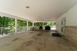 CARPORT WITH DOORS LEADING TO THE MAIN FLOOR OPEN LIVING ROOM, DINING & KITCHEN AREAS